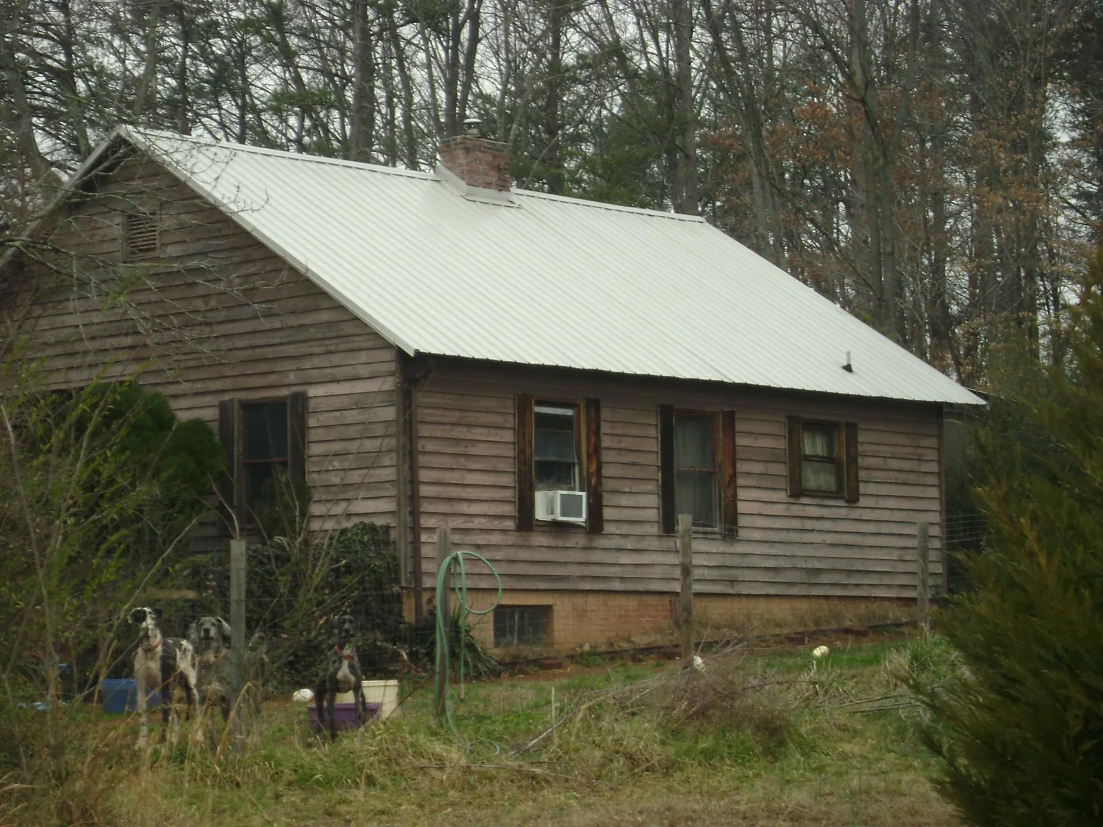 White metal roof on an old wood sided farmhouse, from a Metal Roof Installation job in Roscoe